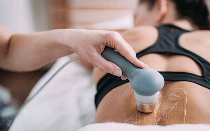 Ultrasound therapy being performed on low back pain